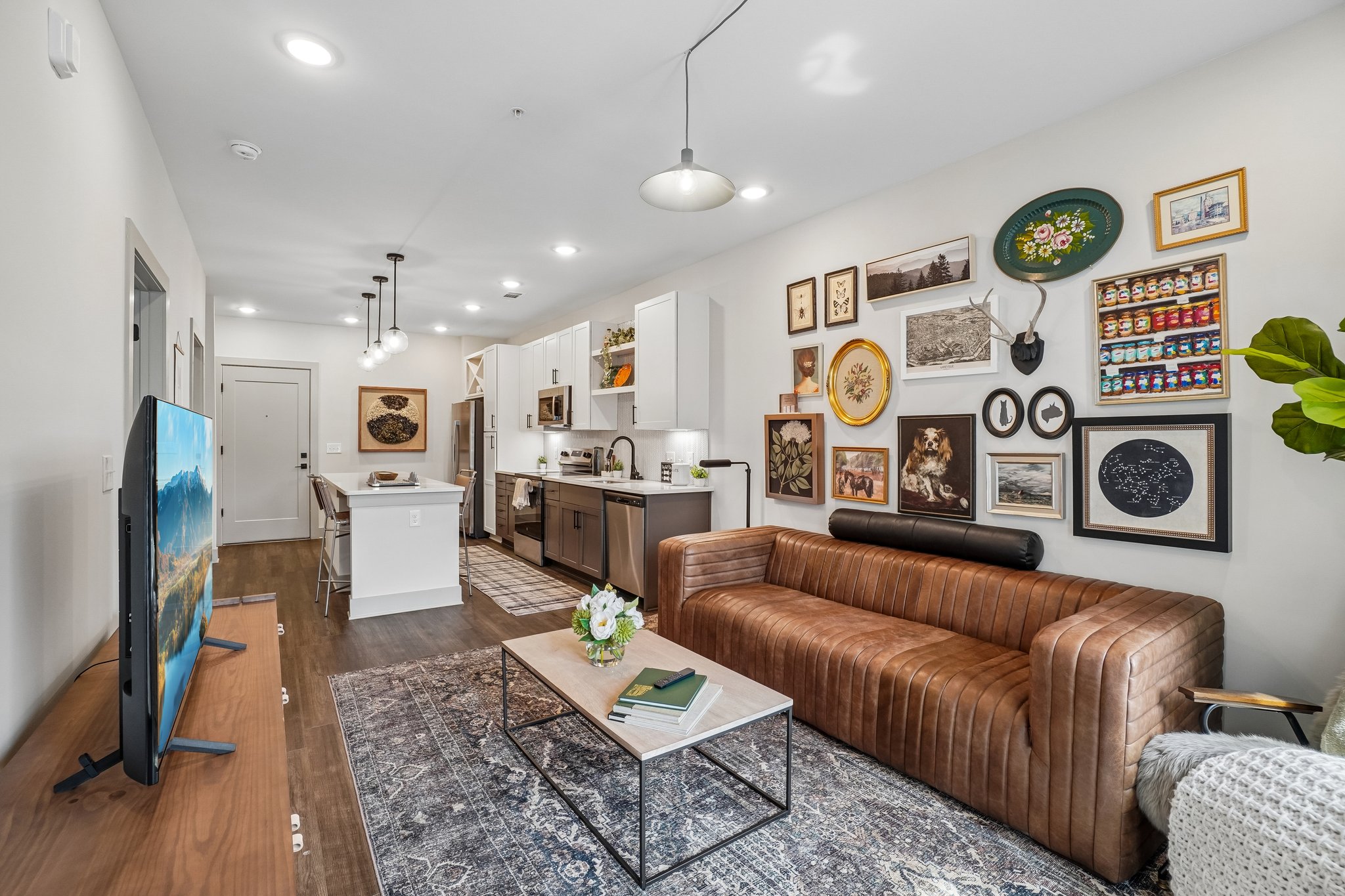 Open living room and kitchen of a model apartment at The Avery